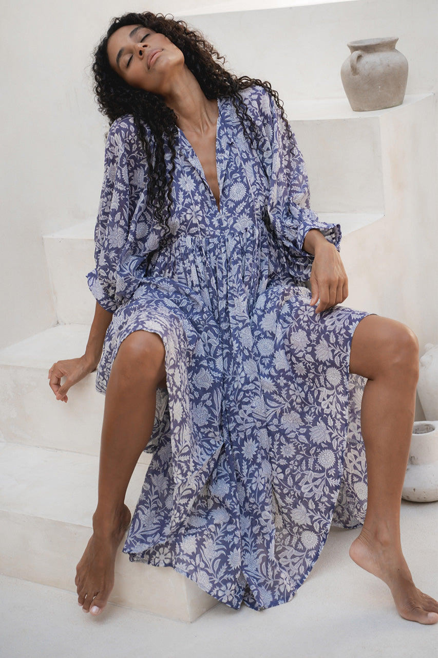 Kyra Midi Dress Blue Iris — seated on white steps, hand block print blue floral cotton midi | Daughters of India